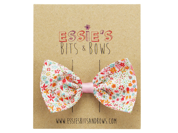 Liberty print Eve pink hair bow on a display board