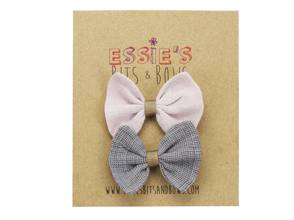 Blush pink and grey linen baby bows on a display card